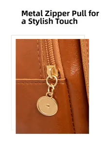 Detailed close-up of premium golden hardware zipper pull on brown oil wax leather backpack