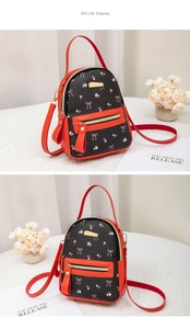 Close-up of mini floral backpack featuring red leather trim and golden zipper detail