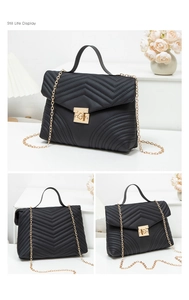 Three views of a black quilted crossbody bag with gold chain strap and wave lock