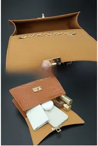 Internal view of brown crocodile texture bag showing capacity for phone and accessories