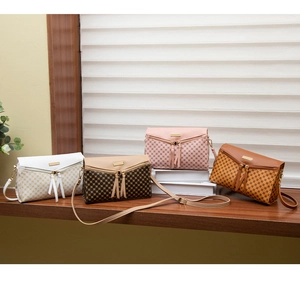Detail view of stylish checkered crossbody bags in four colors with long leather tassels