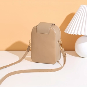 Detail of khaki PU leather crossbody bag with elegant gold zipper and flap design