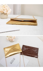 Detail of stone textured envelope clutches in gold and brown with gold metal chains
