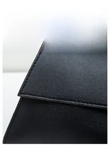 Gros plan du sac baguette en cuir noir montrant la texture fine et les coutures de précision