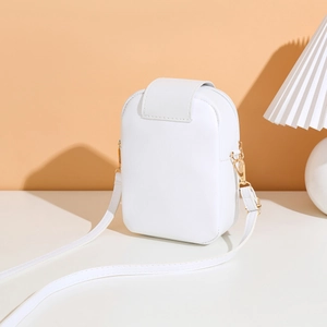 Detail of white leather phone crossbody bag with gold hooks on warm minimalist background