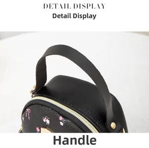 Detail of floral print mini backpack handle with premium gold metal zippers