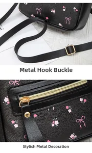 Detail of gold metal hooks and zippers on black floral backpack with pink cherry patterns