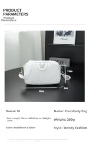 White wave-quilted PU leather camera bag with a gold butterfly buckle closure detail
