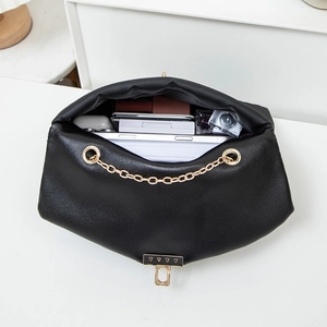Black wave textured crossbody bag with gold chain showing spacious interior storage