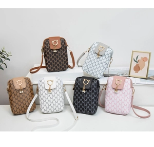 Detail view of mini crossbody phone bags with letter pattern and pearl chain charms