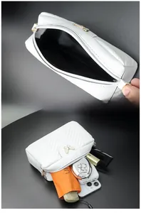 Internal view of a white quilted camera bag showing large capacity for daily items