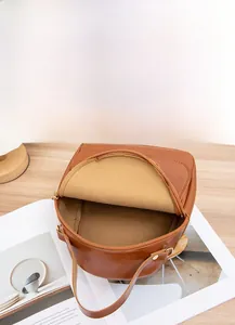 Detailed interior of brown oil wax leather backpack showing multi-layer storage space