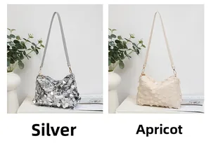 Detail view of silver and apricot sequin shoulder bags with metallic textured finish