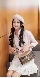 Fashionable floral print crossbody bag with dual tassel zippers and slim shoulder strap