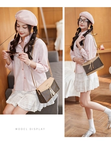 Detail view of stylish checkered crossbody bag with fringe tassel and leather strap