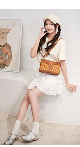 Brown crossbody bag with printed patterns and elegant long tassels in a lifestyle shot