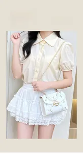 Close-up of white mini square bag with floral embroidery and elegant pearl handle