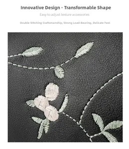 Makrodetail der Blumenstickerei auf schwarzem Leder mit verstärkter Naht am Zylinderbeutel