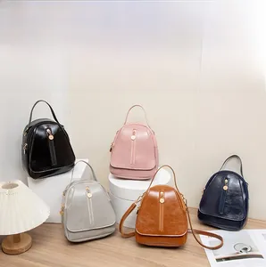 Collection of polished faux leather mini backpacks in black, pink, silver, and tan colors
