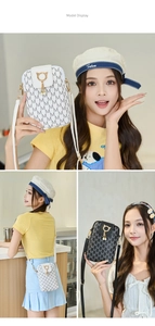 Detail of printed crossbody phone bag with gold cat buckle and pearl tassel fringe