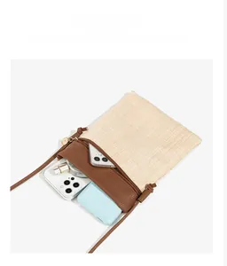 Interior capacity detail of straw and brown leather woven mini crossbody bag