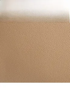 Detailed macro view of the premium brown lychee grain leather with a soft textured finish