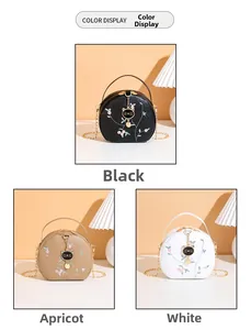 Three semi-round bags with floral embroidery and cat charms in black, apricot, and white