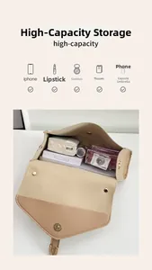 Interior view showing the large storage capacity of the beige leather shoulder bag