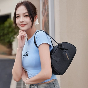 Chic black lychee leather shoulder bag with semicircular design and elegant strap