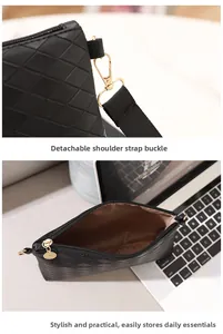 Detail of black quilted PU leather bag with gold zipper and brown fabric lining