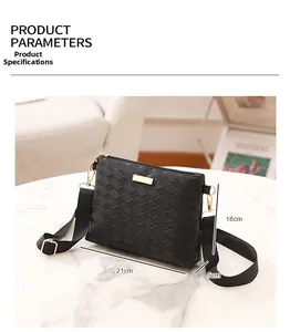 Detail view of black quilted crossbody bag with adjustable strap and golden metal hardware