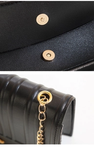 Detailansicht des Magnetverschlusses und der goldenen Kette einer schwarzen Stepptasche