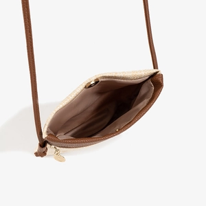 Chic woven beach crossbody bag with brown leather accents and magnetic closure