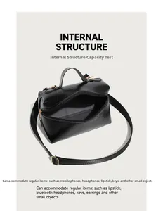 Top view of black oil wax leather handbag showing spacious internal storage and zippers