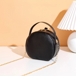 Elegant black circular crossbody bag with floral embroidery and gold chain strap