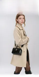 Fashionable black leather box handbag styled with a classic beige trench coat for women