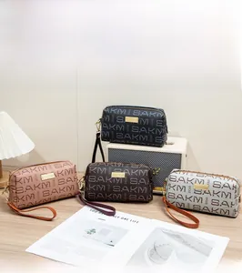 Detail of vintage patterned clutch bags with leather straps and gold zippers in various colors