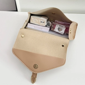 Minimalist leather crossbody square bag in beige with interior storage view