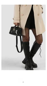 Street style view of shiny black leather handbag with heart-patterned stockings and boots