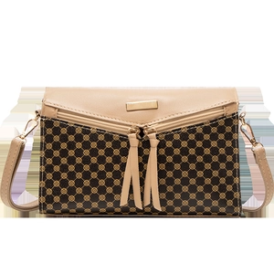 Fashionable brown shoulder bag with vintage floral print and decorative gold metal plate