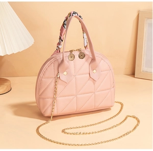 Pink quilted shell bag featuring golden chain strap and silk scarf wrapped handle