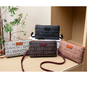Detail view of four patterned crossbody bags in assorted colors with SAKM monogram