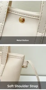 Détail du sac seau crème montrant la boucle dorée et les coutures soignées du cuir