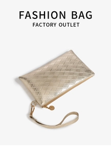 Close-up of golden rectangular clutch featuring luxury quilted texture and wrist strap