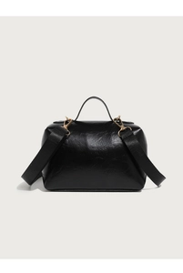 Detail of black oil-wax leather handbag with wide woven strap and gold metal hardware