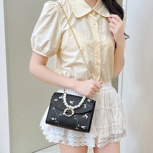 Elegant black embroidered square bag with large pearl handle and gold chain strap