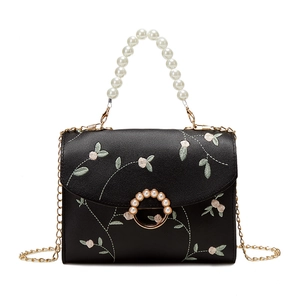 Elegant black embroidered pearl handbag with floral motifs and golden chain strap