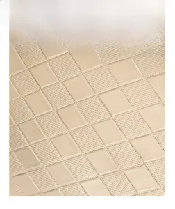 Close-up of beige quilted diamond pattern faux leather texture on lady's clutch bag