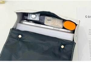 Macro view showing the large capacity and interior of the white quilted leather handbag