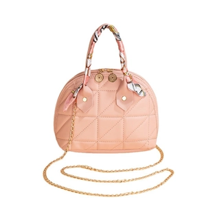Pink quilted shell bag with gold chain strap and decorative silk scarf handles